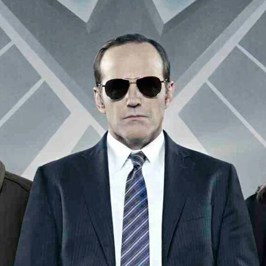 An image from an outdated WIRED interview with Clark Gregg in sunglasses in front of a Agents of S.H.I.E.L.D. logo